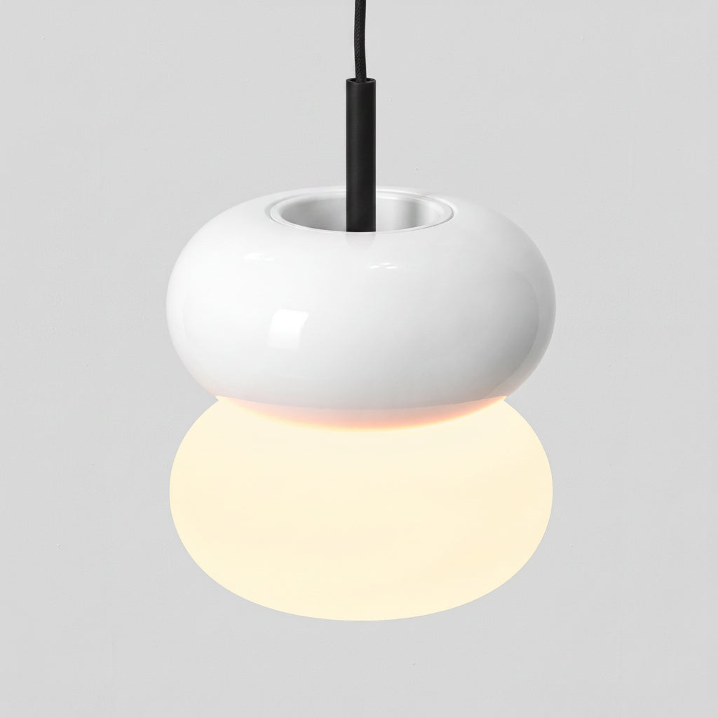White pendant light with a spherical base and a black cord