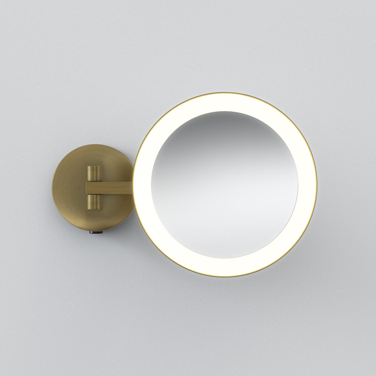 Round brass vanity mirror with an illuminated edge