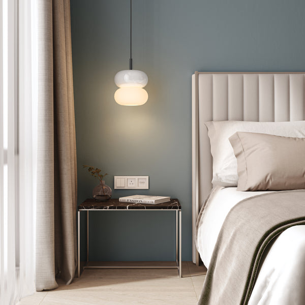 Bedroom with a bed, nightstand, and pendant light