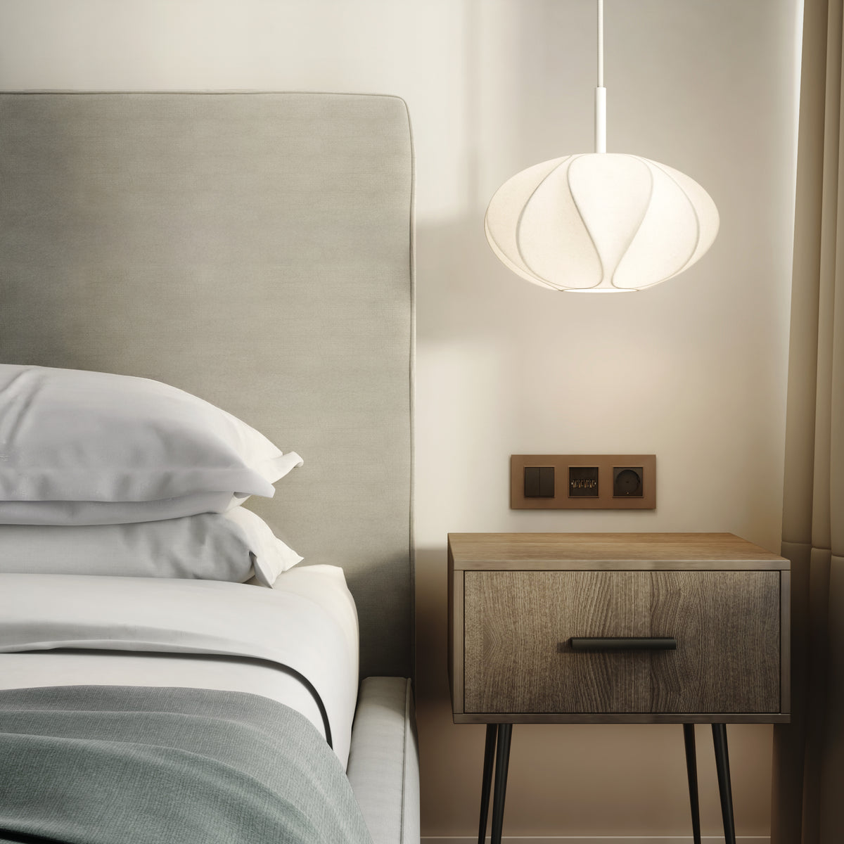 Bedroom with a bed, white pillows, a wooden nightstand, and a white pendant light