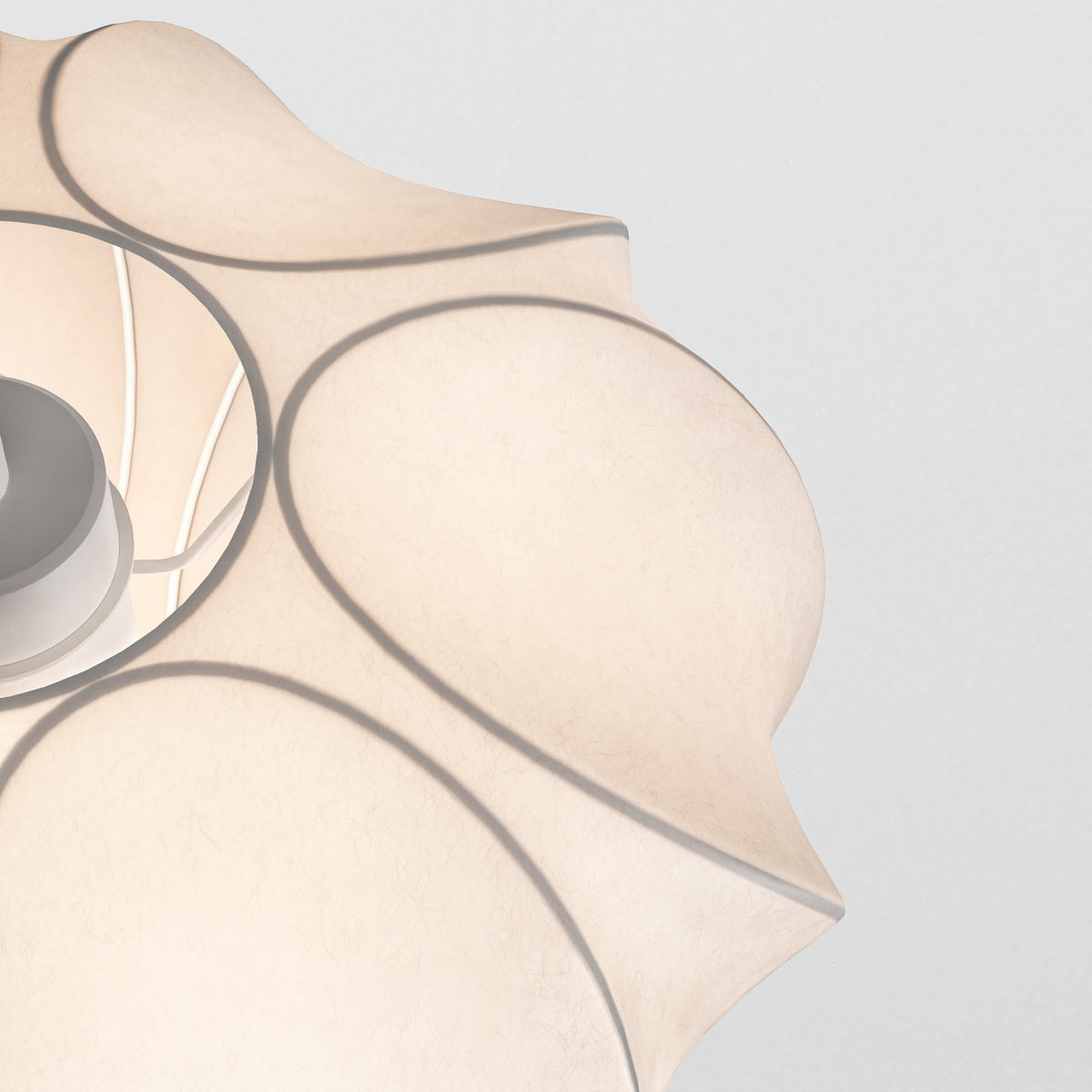 Close up of a white pendant light with a wavy, organic shape