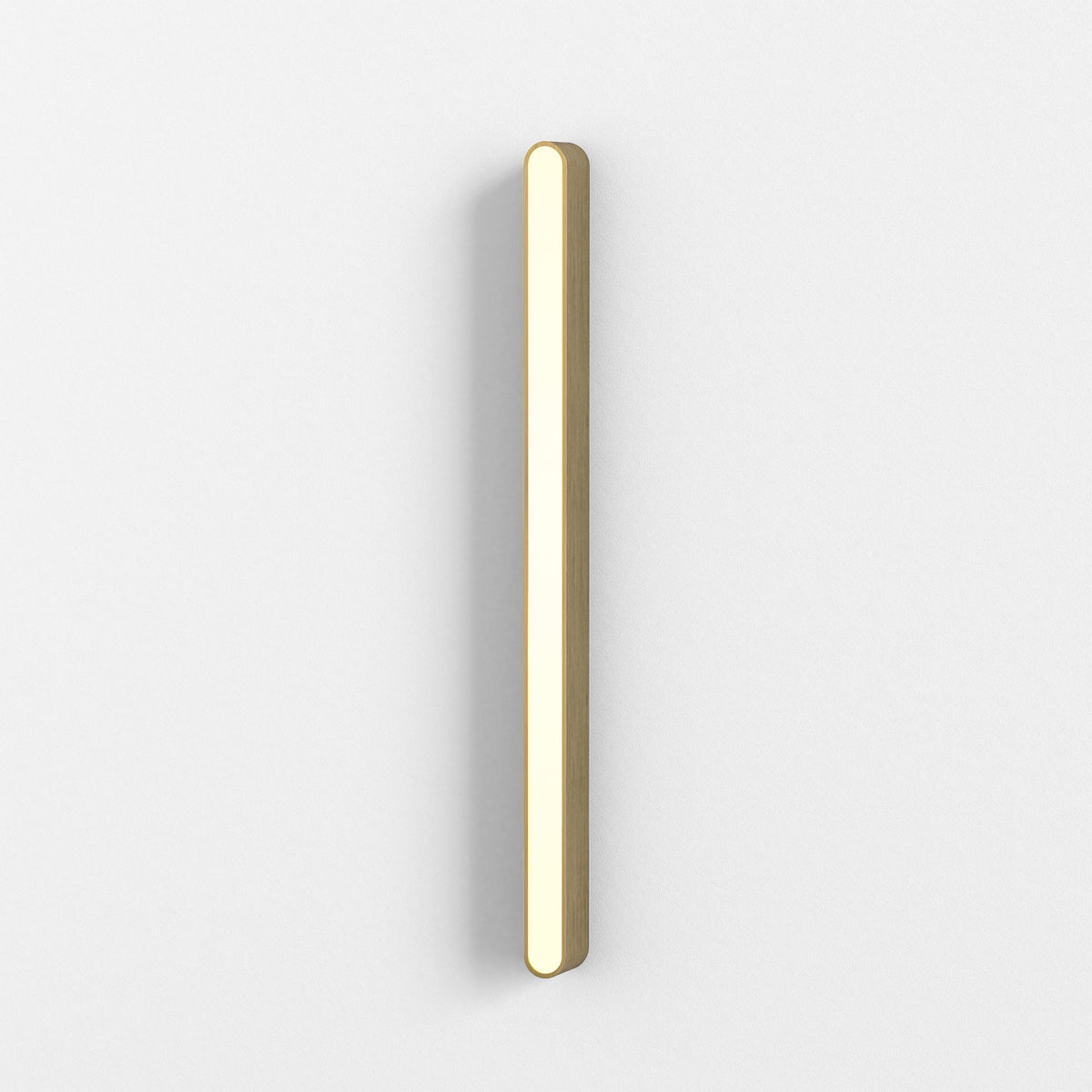 Vertical wooden light fixture with rounded ends, emitting a warm glow on a white wall