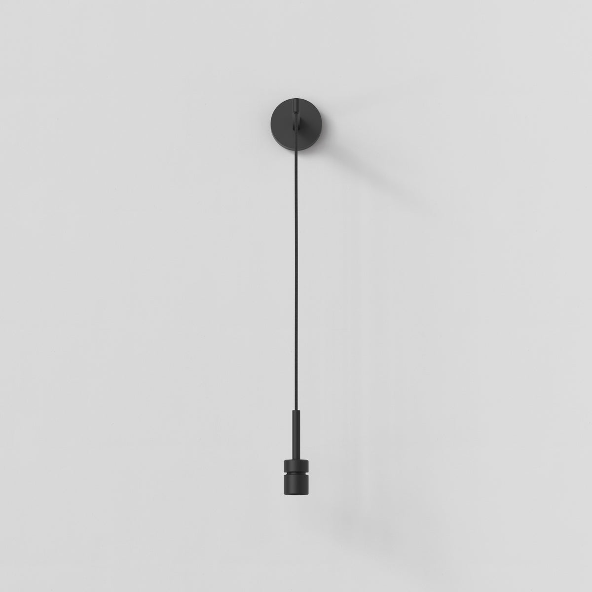 Black wall light with a circular base and a long, thin stem ending in a cylindrical light fixture