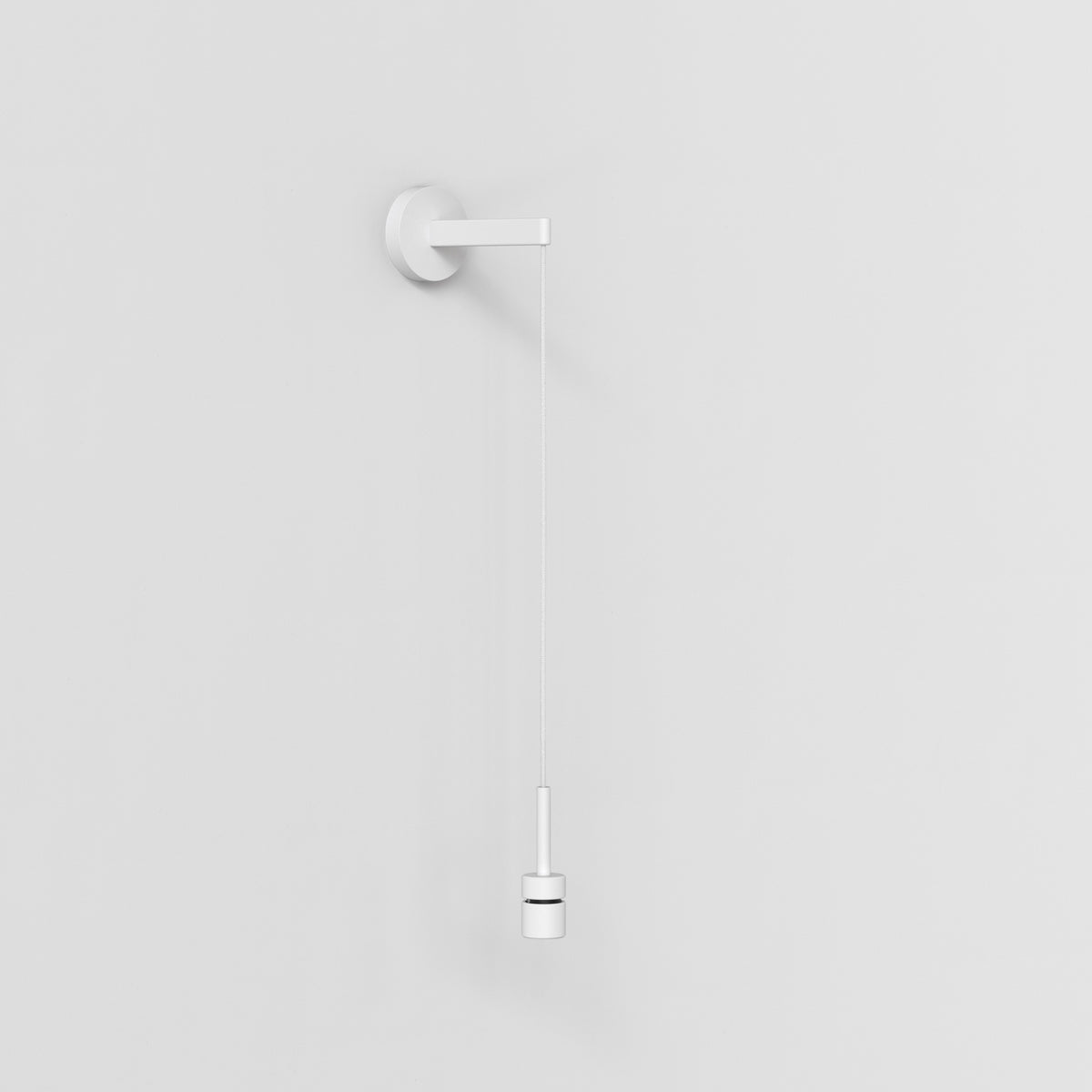 White pull cord switch with a cylindrical handle against a white wall