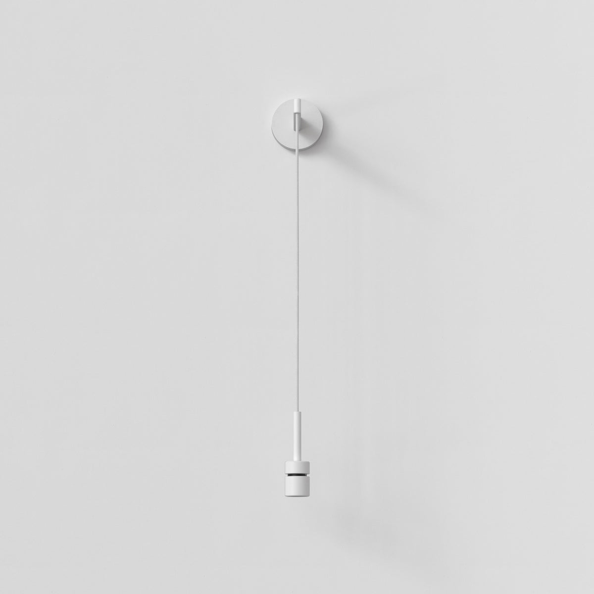 White wall-mounted light switch with a pull cord and a cylindrical handle