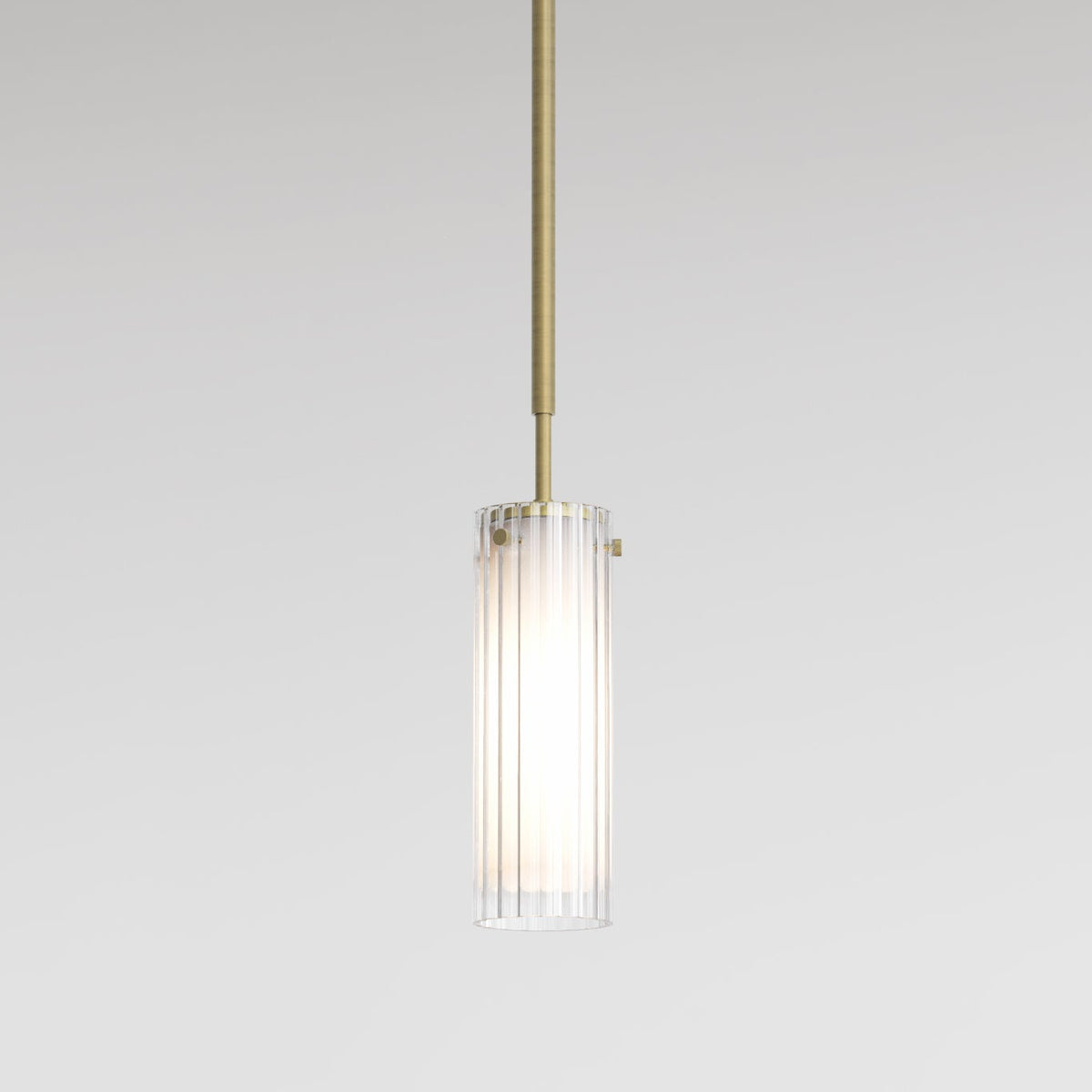 A close up of a single pendant light fixture with a ribbed glass shade and a brass rod