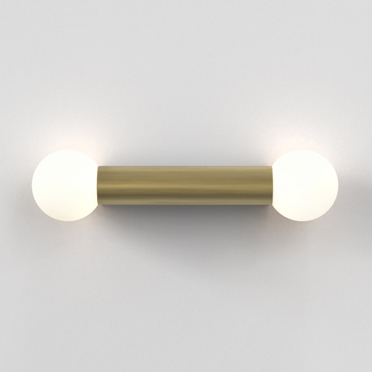 Brass wall light with two spherical bulbs
