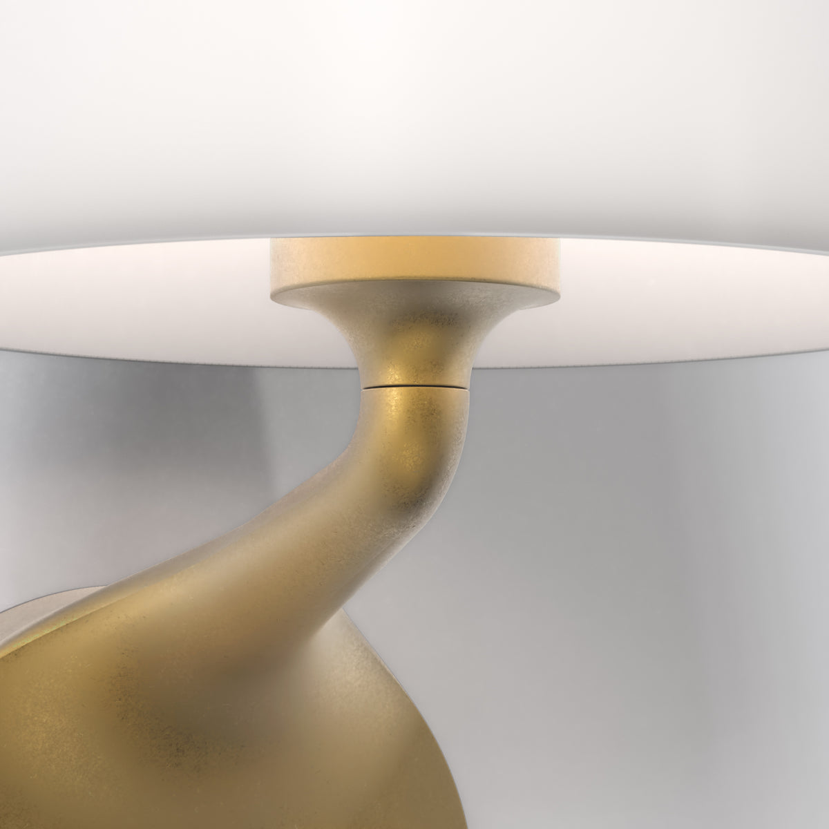 Close up of a gold lamp base with a white lampshade