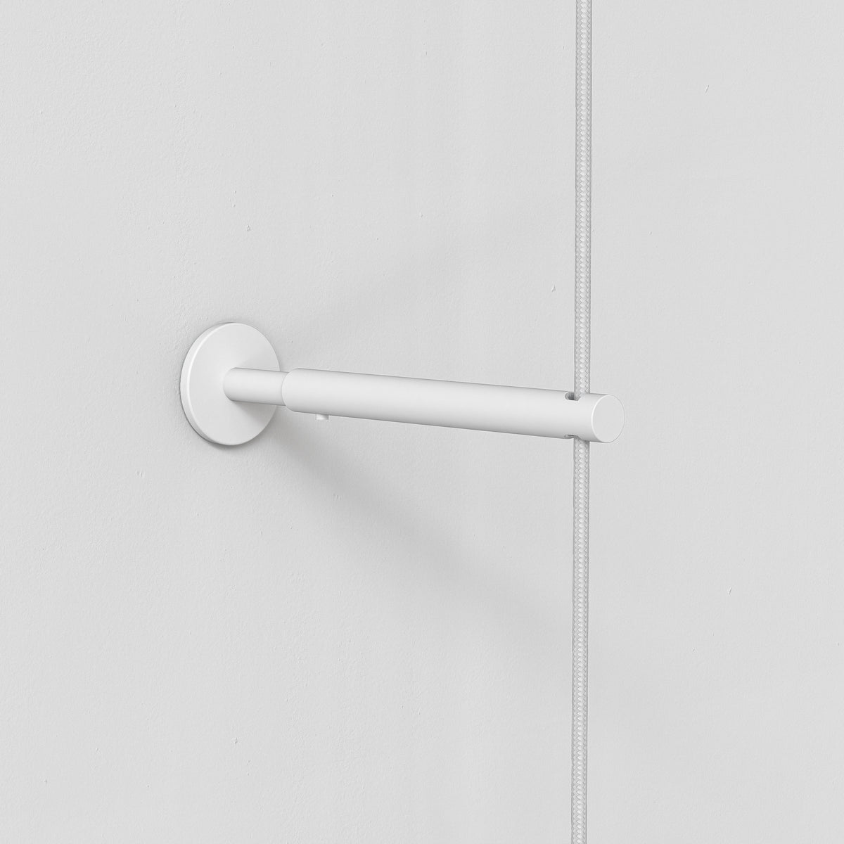 White wall mount with a horizontal bar holding a braided white cable