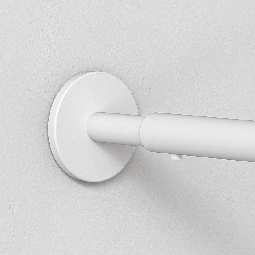 White curtain rod bracket mounted on a white wall