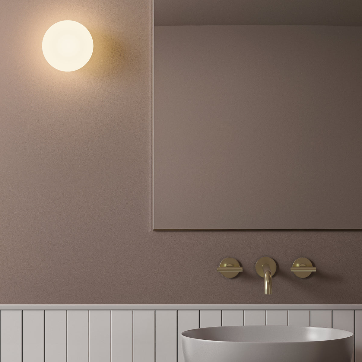Bathroom with a round wall light, a mirror, a gold faucet, and a white sink