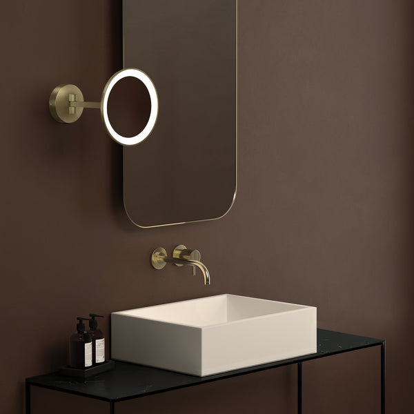 Bathroom with a rectangular mirror, a wall-mounted faucet, a white rectangular sink, and two soap dispensers