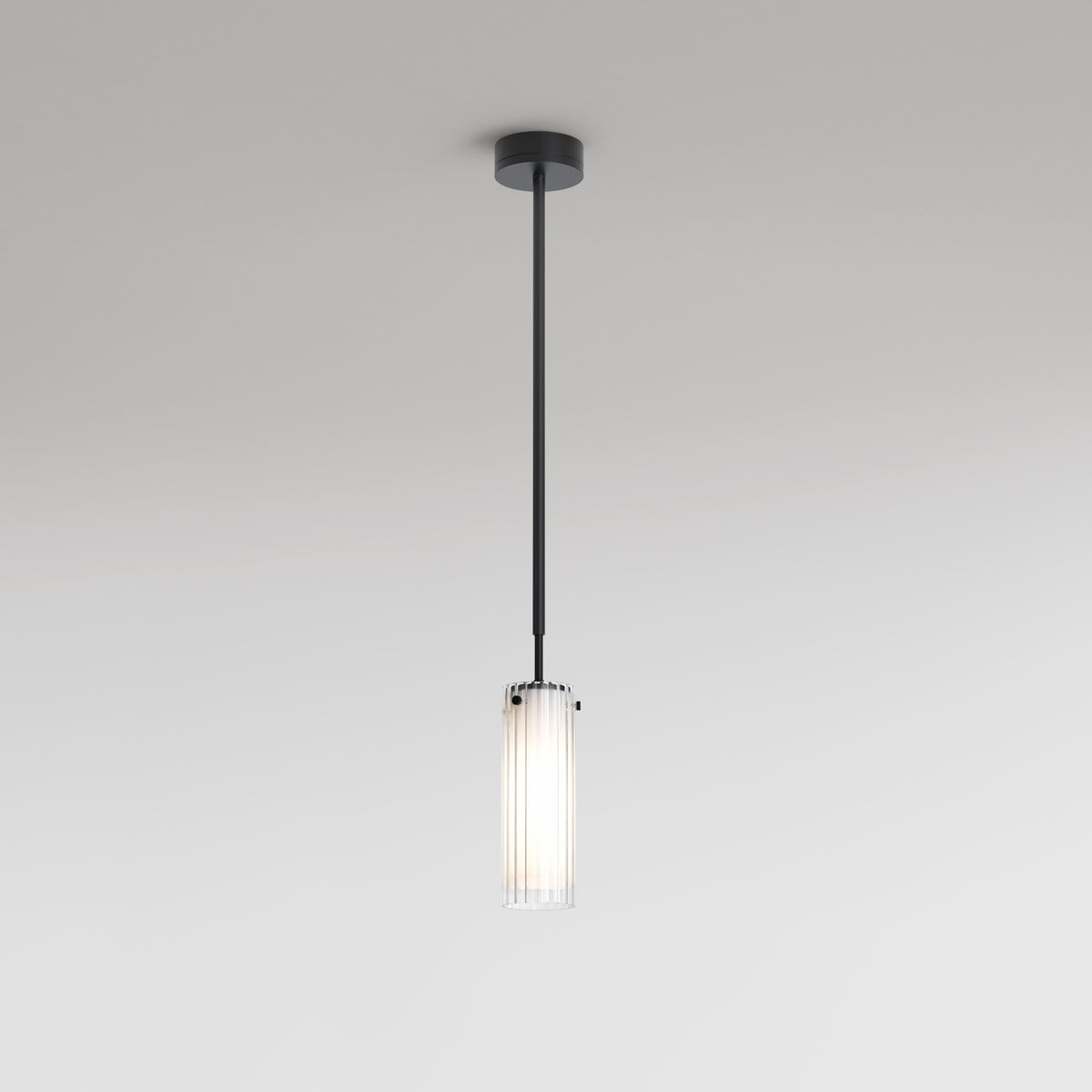Black pendant light with a clear fluted glass shade