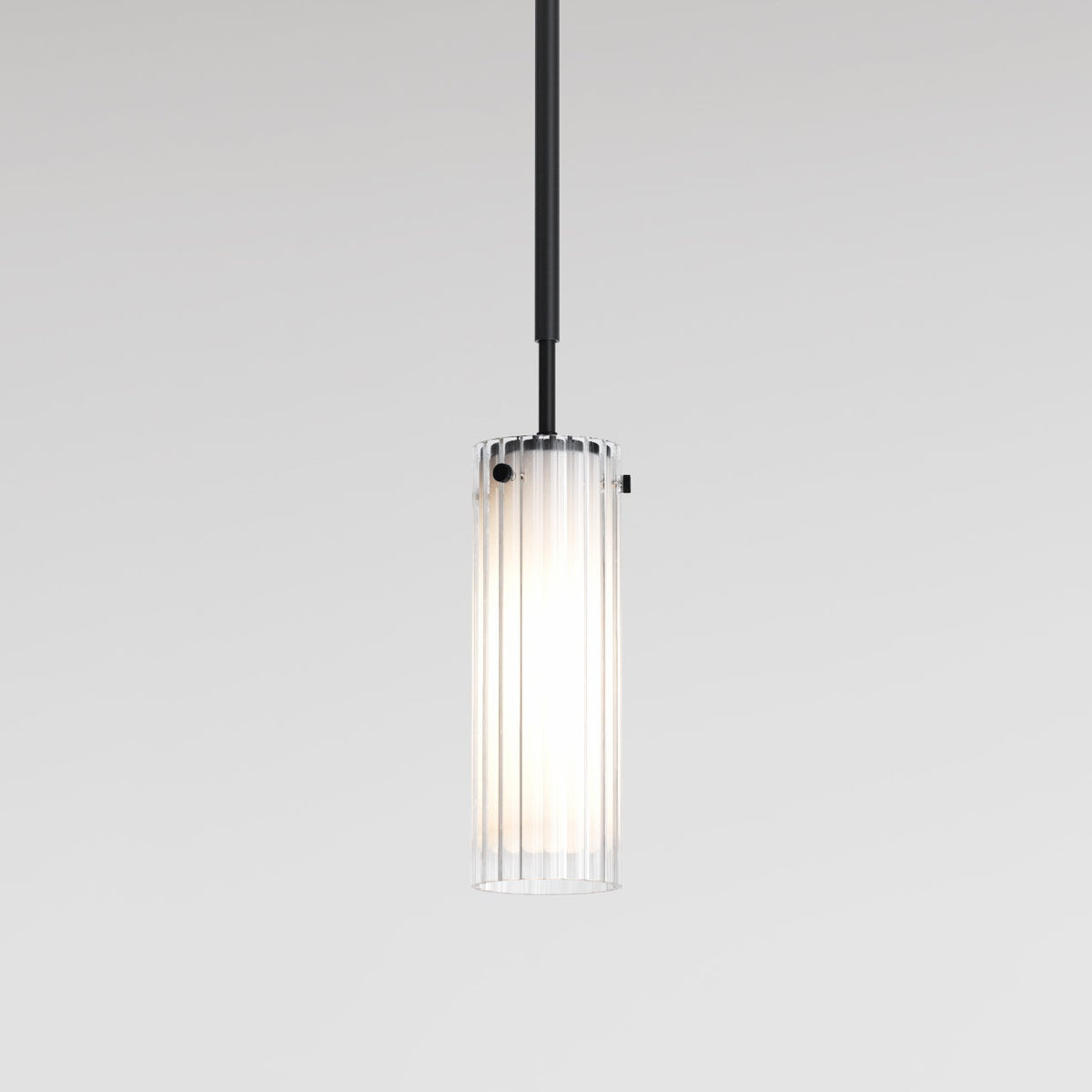 Cylindrical pendant light with fluted glass shade and black rod