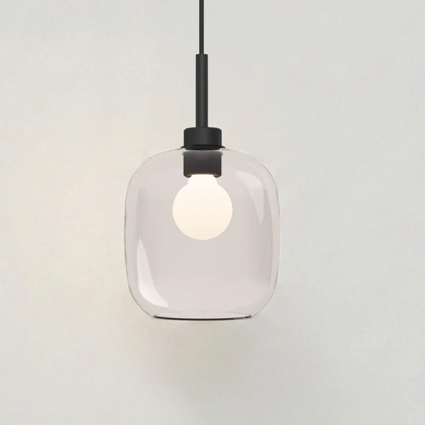 Clear glass pendant light with a black fixture and a white bulb