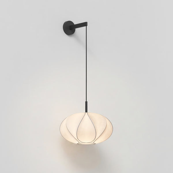 White pendant lamp with a black cord and wall mount