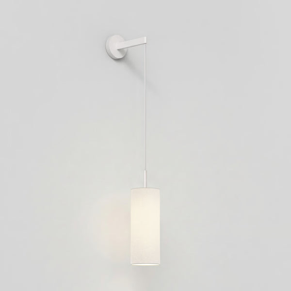 White wall-mounted light fixture with a cylindrical fabric shade