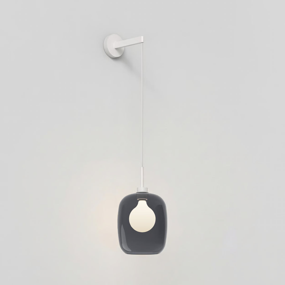 Wall-mounted pendant light with a dark grey rounded glass shade and a white bulb