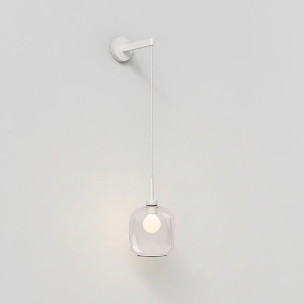 White wall lamp with a clear glass shade and a glowing bulb