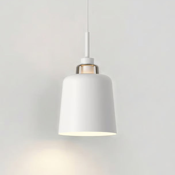White pendant light with a bell-shaped shade and a subtle gold accent near the top, hanging against a white wall