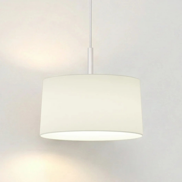 White drum pendant light with a fabric shade hanging from the ceiling