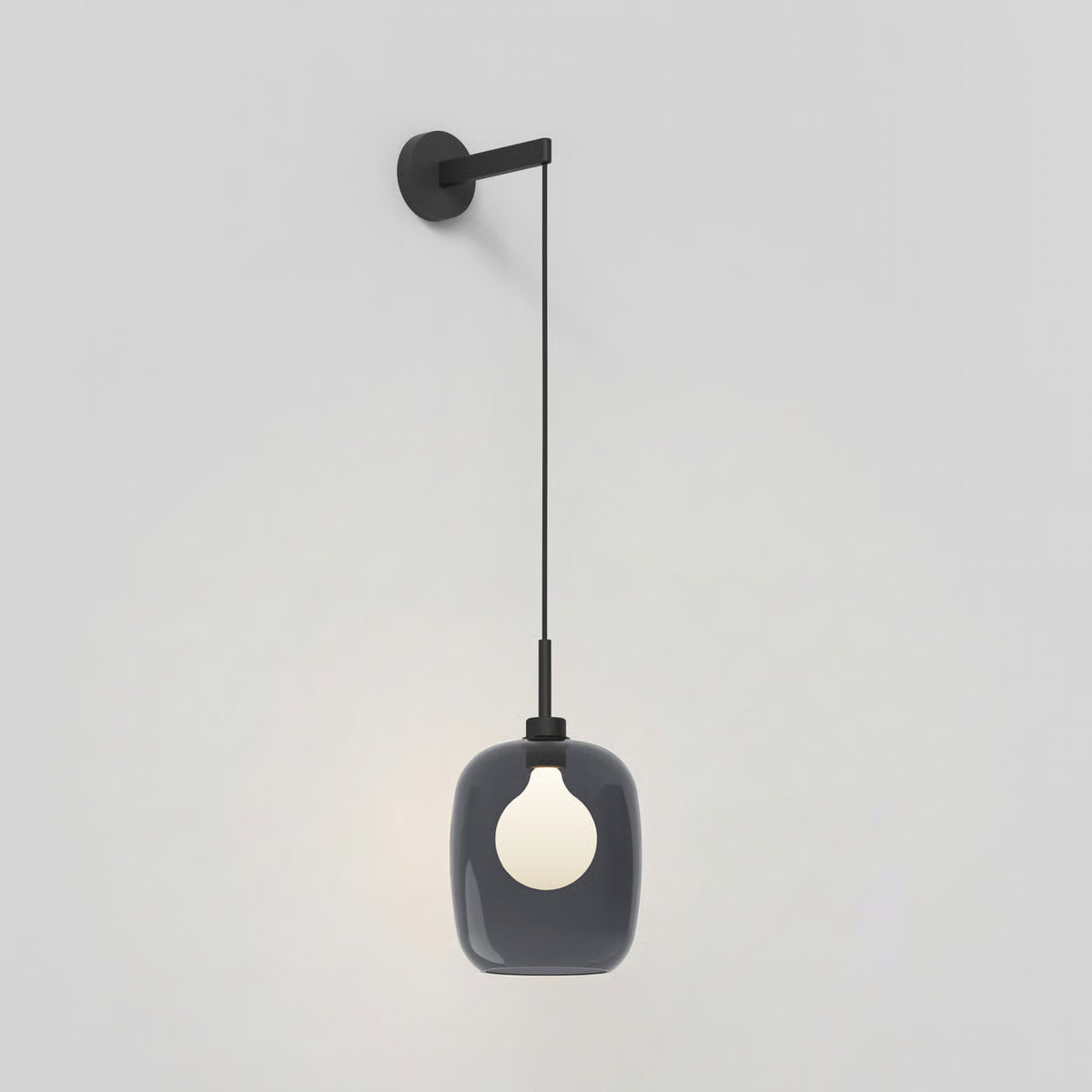 Black wall-mounted light fixture with a dark grey glass shade and a white bulb