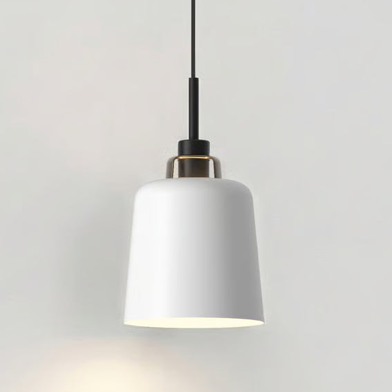 White pendant light with black cord and brass accent