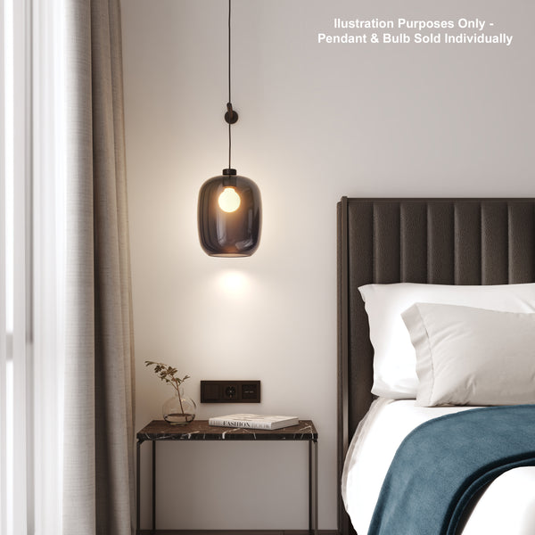 A bedroom with a dark grey pendant light hanging above a marble side table next to a bed