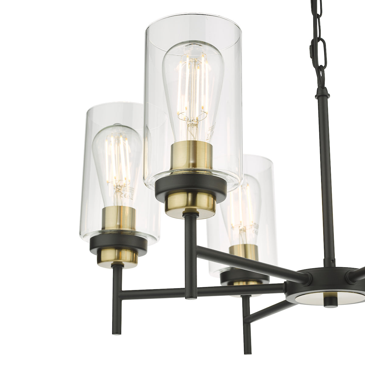 Close-up of a black and brass chandelier with three clear glass shades and exposed filament bulbs.