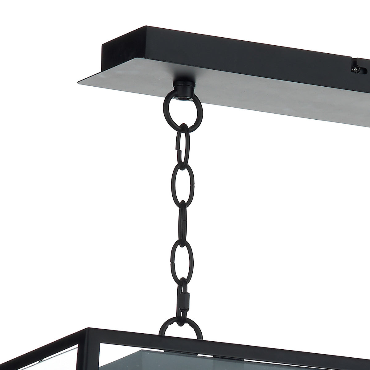 Close-up of a black metal chain connecting a ceiling mount to a rectangular light fixture.