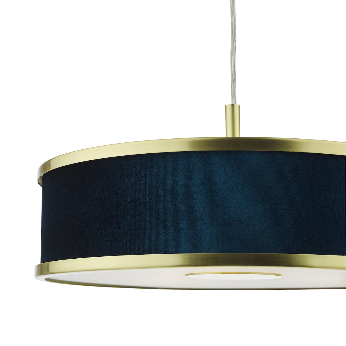 Close-up of a pendant light with a dark blue fabric shade and brass accents.