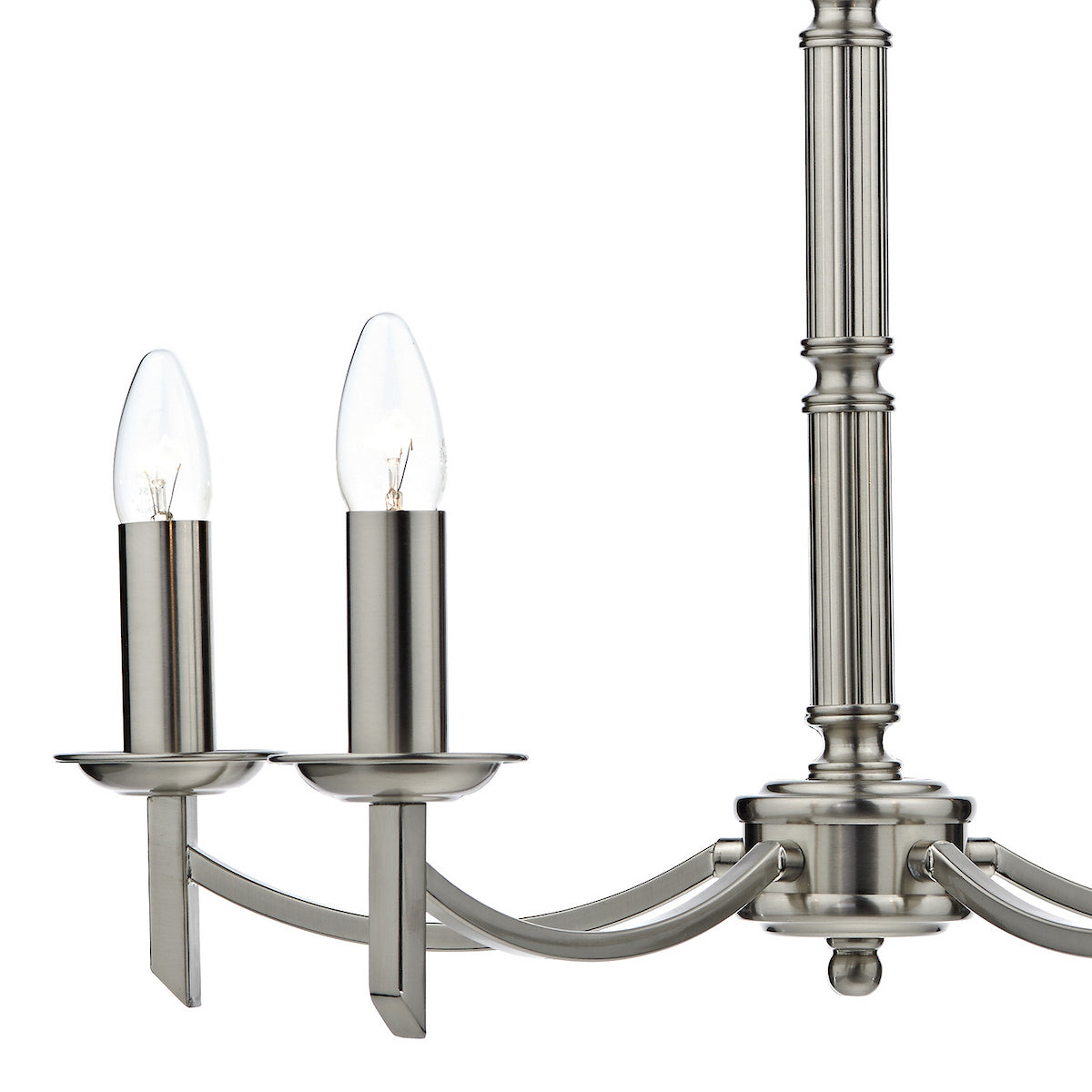 Close-up of a brushed nickel chandelier with two candle-style bulbs and a fluted central column.
