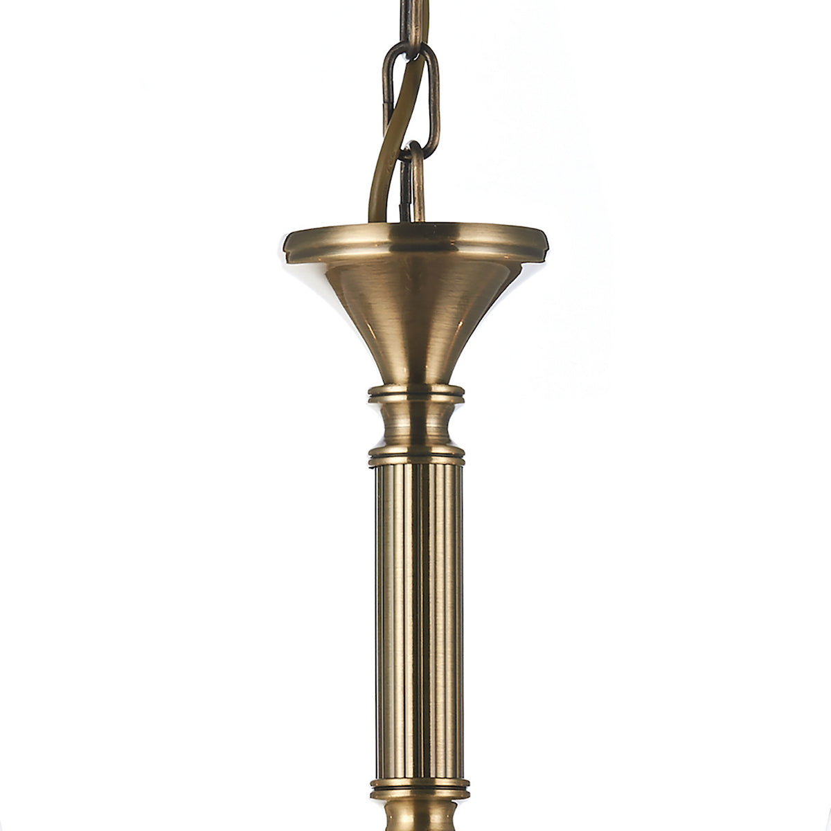Close-up of a brass chandelier chain and decorative column against a white background.