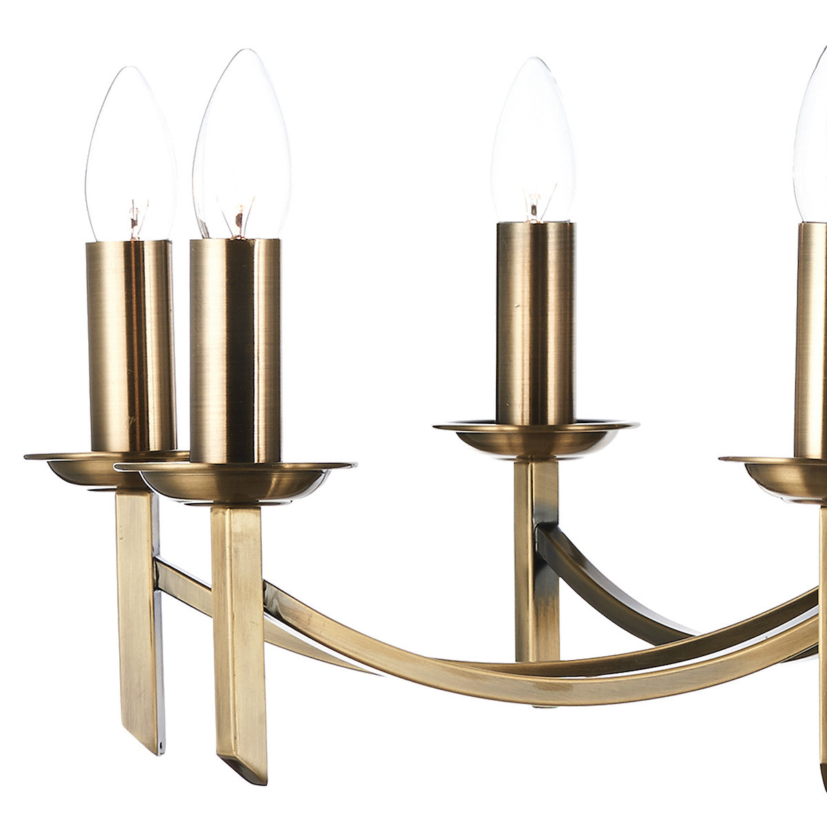 Close-up of a brass chandelier with four candle-shaped light bulbs.