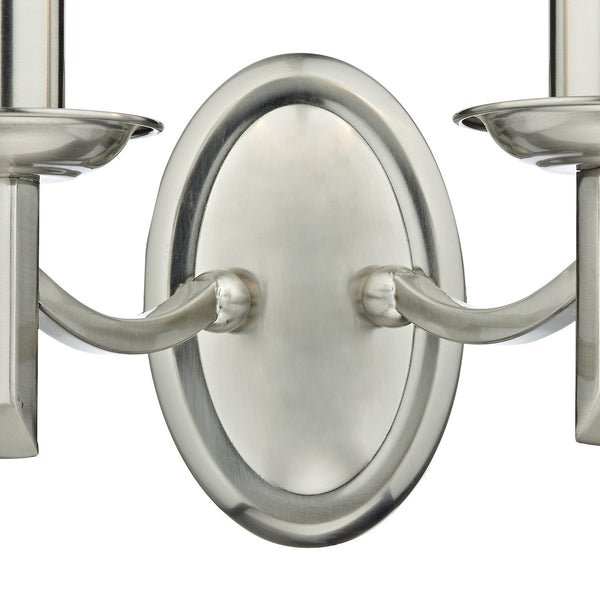 Brushed nickel wall sconce with two candle-style lights and an oval backplate.