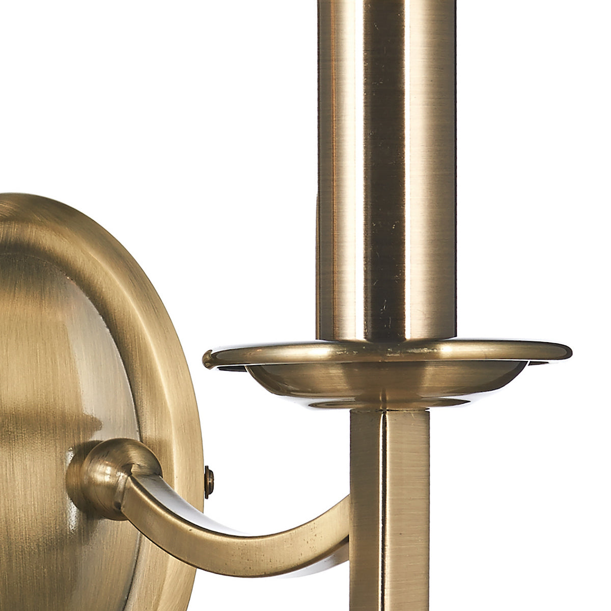 Close-up of a brass wall sconce with a candle holder.