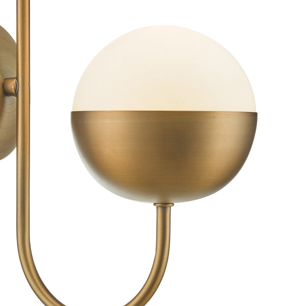 Modern brass wall sconce with a half-frosted, half-brass spherical shade.