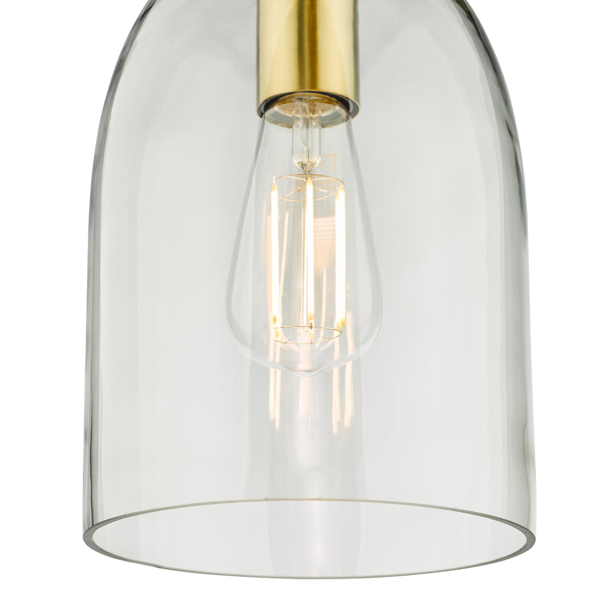 Close-up of a clear glass pendant light with a brass fixture and an exposed filament bulb.