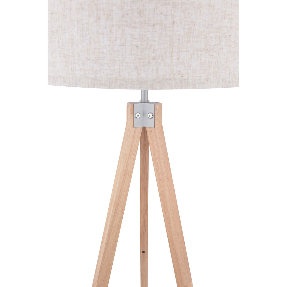 Close-up of a tripod floor lamp with a light wood base and a beige fabric shade.