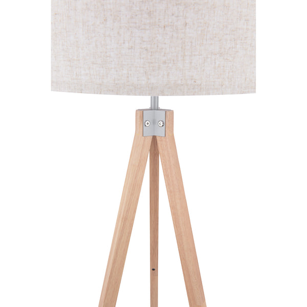 Close-up of a tripod floor lamp with a light wood base and a beige fabric shade.