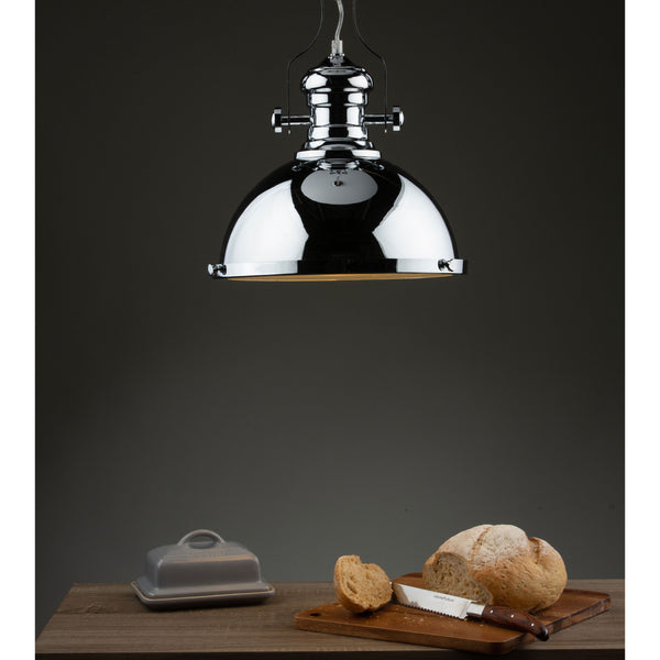 A chrome pendant light illuminates a wooden table with a loaf of bread, a knife, and a butter dish.