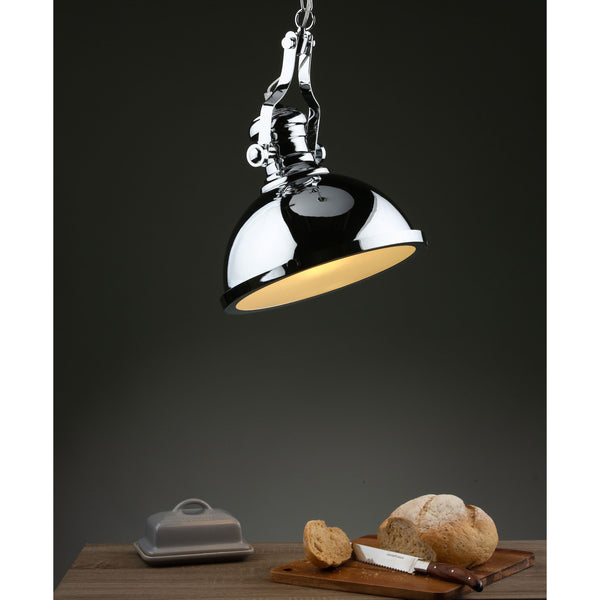 A chrome pendant light illuminates a wooden table with bread, a knife, and a butter dish.
