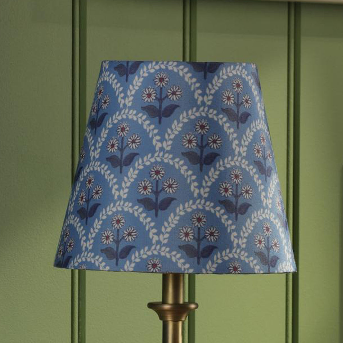 Joules Apsley rechargeable wall light featuring a blue cotton shade with a floral pattern on a brass base