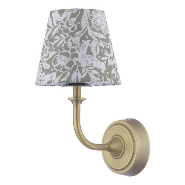 Antique brass wall lamp with a tapered green and white floral fabric shade
