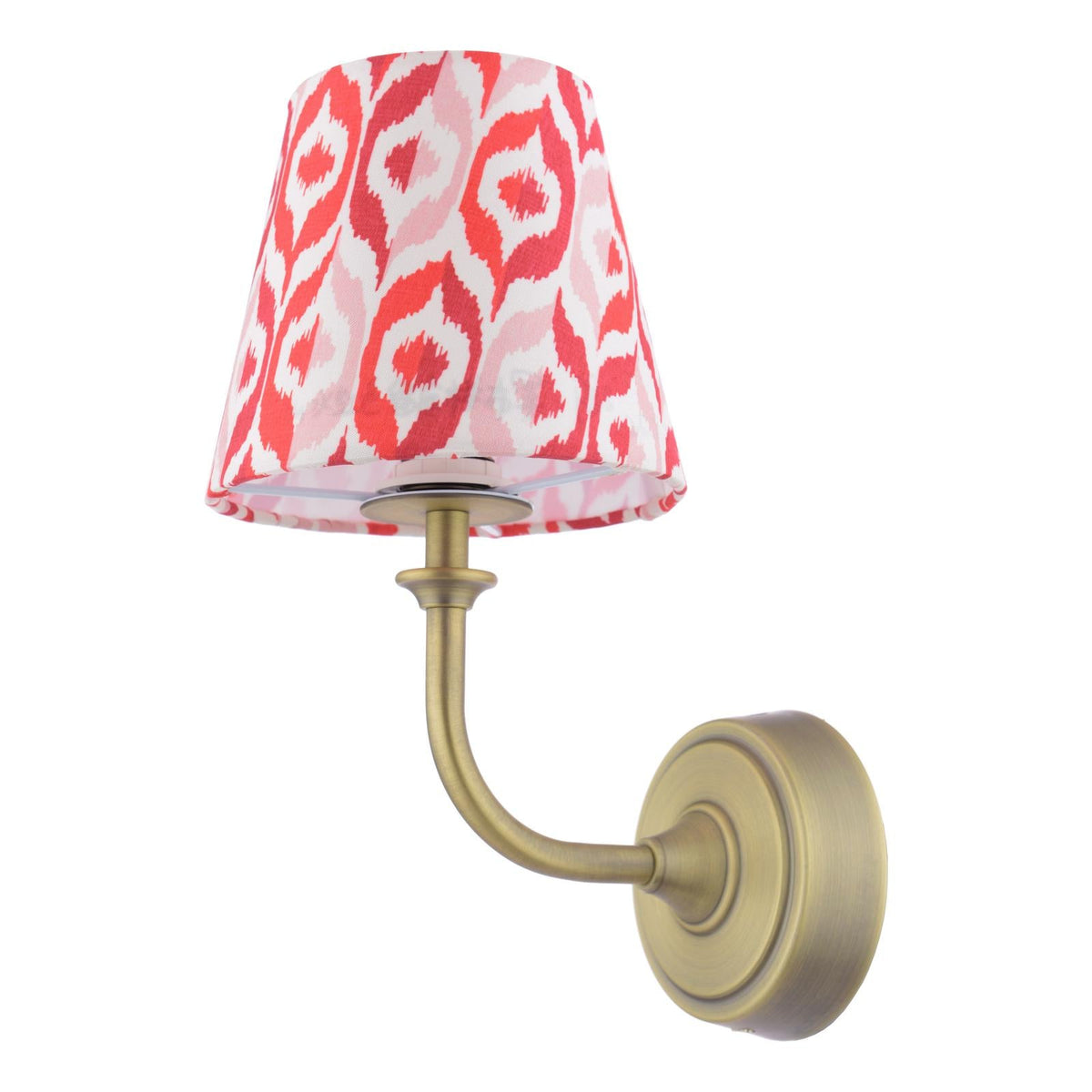 Wall lamp with a brass finish arm and a red and white ikat patterned fabric shade