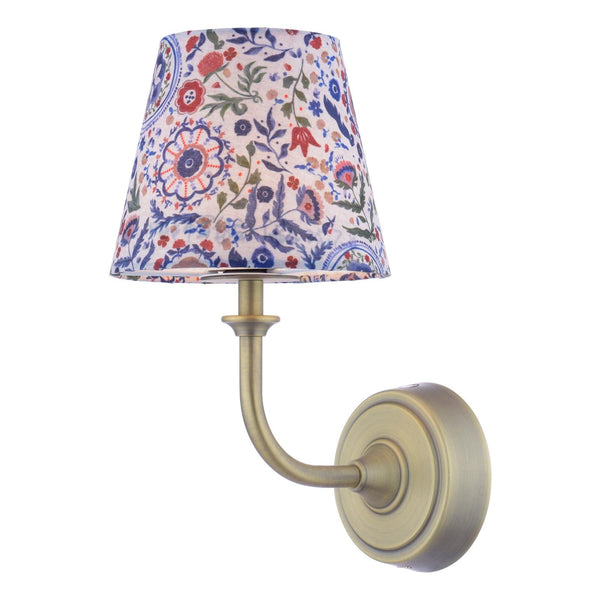Antique brass wall lamp with a floral patterned fabric shade