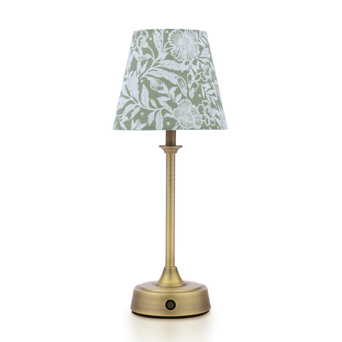 Table lamp with a brass base and a green floral fabric shade