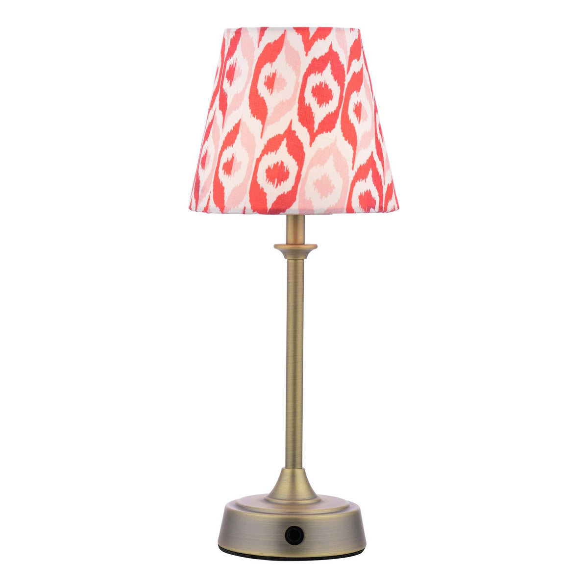 Table lamp with a brass base and a red and pink ikat patterned fabric shade