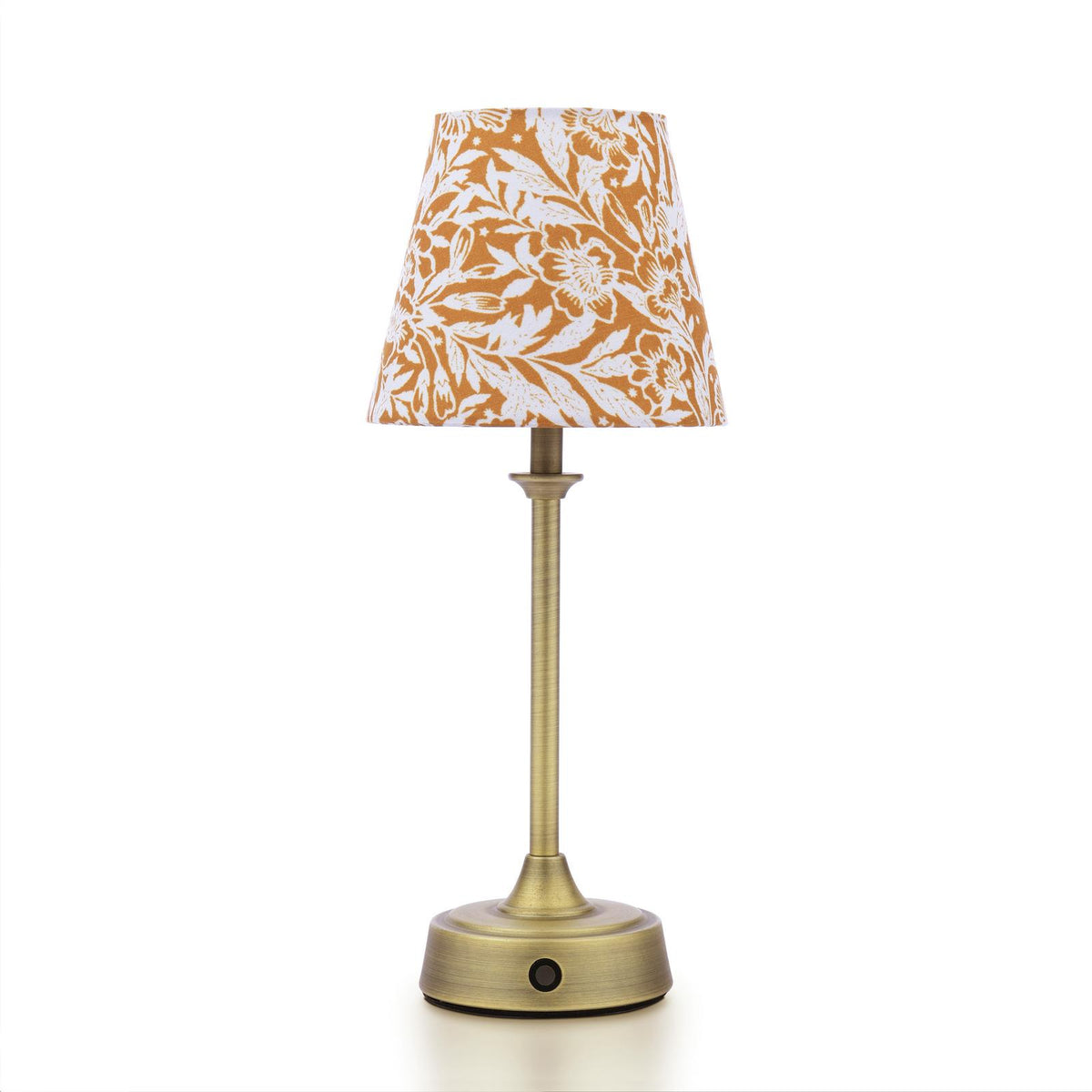 Table lamp with a brass base and a mustard yellow floral patterned fabric shade