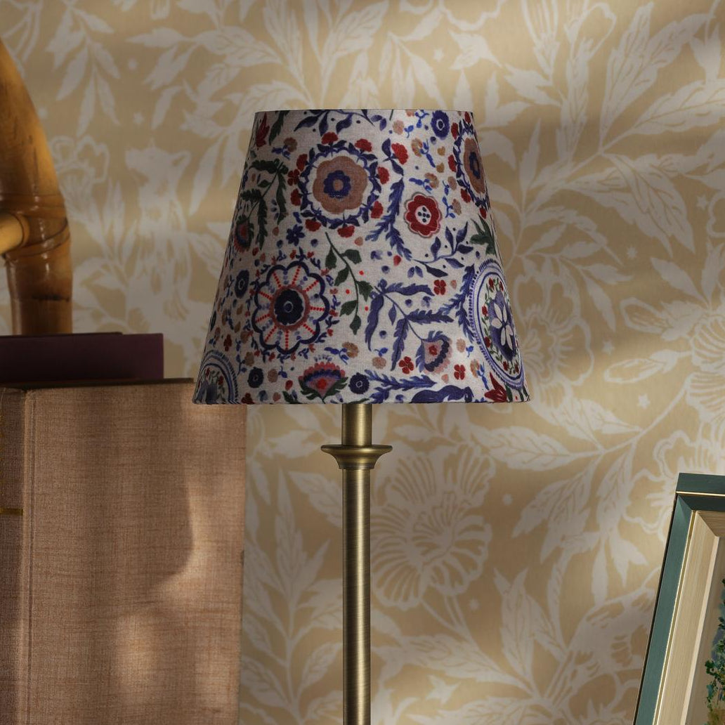 Joules Apsley rechargeable table lamp with a matt antique brass base and a multi colour floral cotton shade